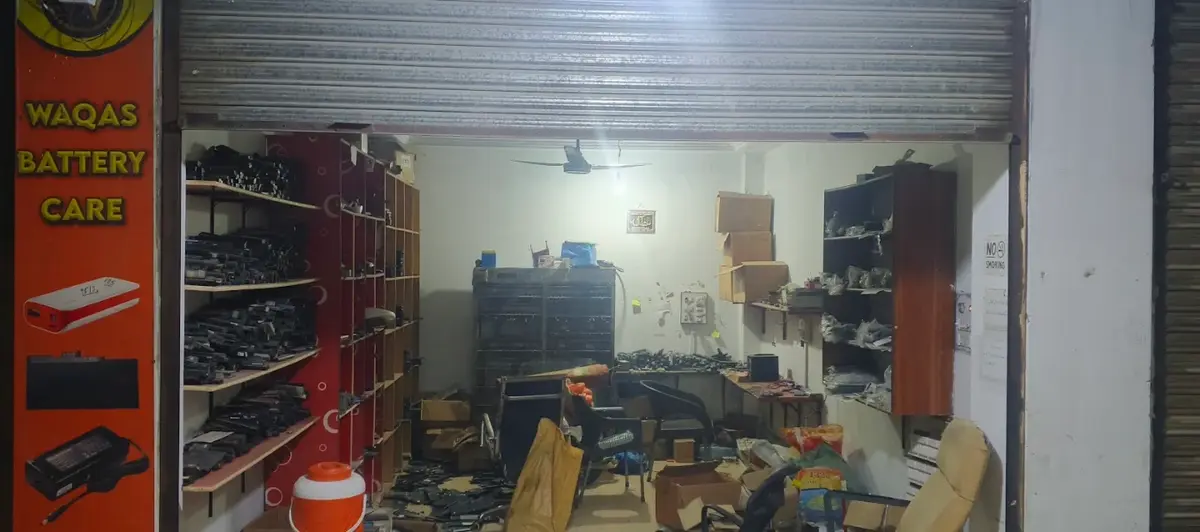 Shelves of laptop batteries inside Waqas Battery Care, Bahawalpur Trade Center